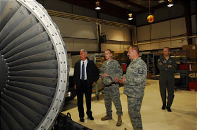 President Dieter F. Uchtdorf with Staff Sgt. Luke Hurst and Master Sgt. Daryl Chadwick examine an ai