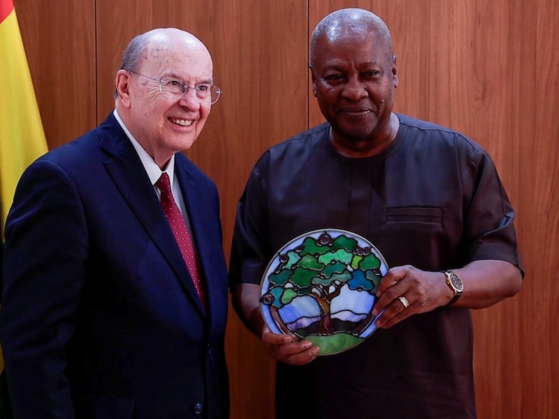 Elder Quentin L. Cook gifts a stained-glass wall hanging of the tree of life to John Dramani Mahama, president of the Republic of Ghana, while visiting Accra, Ghana, Feb. 17, 2026.
