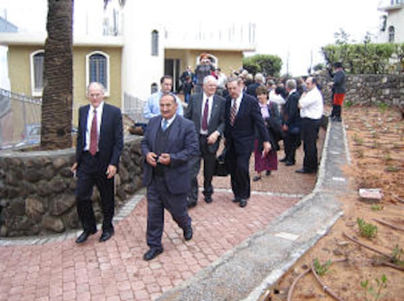Leaving Galilee Branch meetinghouse are Elder Jeffrey R. Holland, center, and branch President Ritch