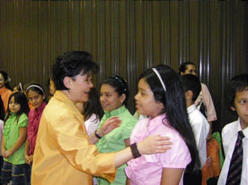 Sister Vicki F. Matsumori, second counselor in the Primary general presidency, greets children in As