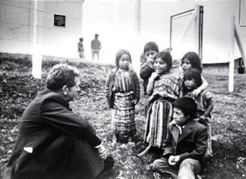 Elder Boyd K. Packer converses with children outside one of the 11 chapels he dedicated in Guatemala