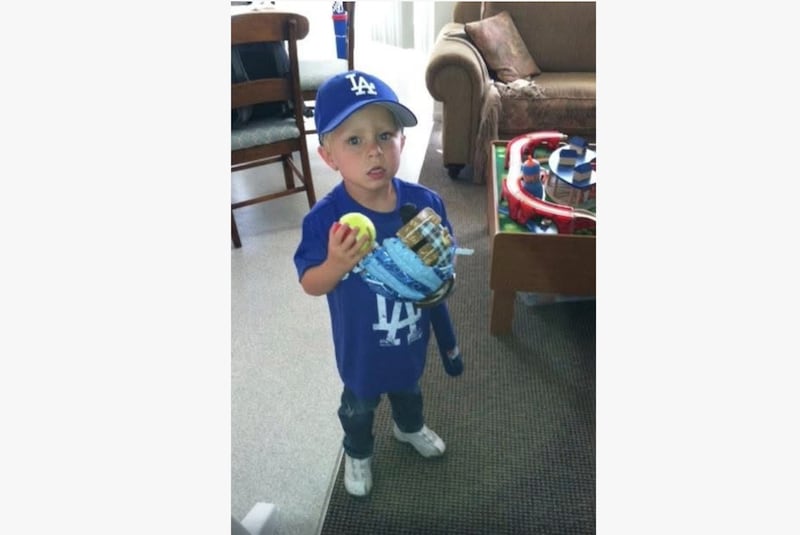 Westin Rich, 3, wears a Los Angeles Dodgers shirt and hat and carries all his baseball gear in a picture taken in May 2012.