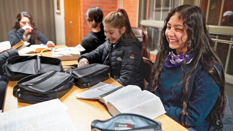 Young men and women attend an early morning seminary class in Argentina.