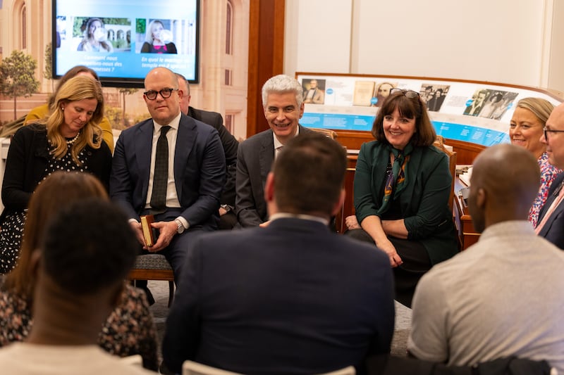 Elder Gérald Caussé of the Quorum of the Twelve Apostles and his wife, Valérie, speak with new converts at the Paris France Visitors’ Center in Versailles, France on Friday, Feb. 27, 2026. To Elder Caussé's right is Elder James W. McConkie III of the Europe Central Area Presidency, and his wife, Laurel.