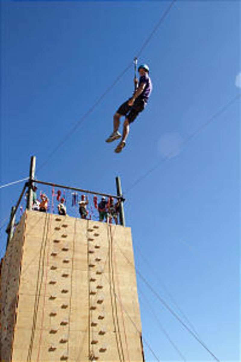 Scouts enjoy the zip line and climbing tower at the 2013 Rise Up Scout Camp. Action centers offered