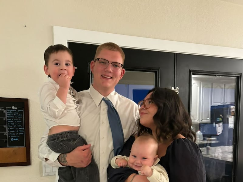 Jadrian and Cambrie Taylor with their two sons, Jadrian Jr., left, and Booker, right, share a moment together in San Tan Valley, Arizona, April 28, 2025.