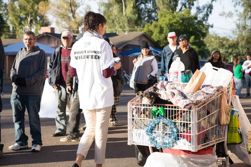 A volunteer helps to register individuals experiencing homelessness during a recent Project Connect event in Phoenix, Arizona.
