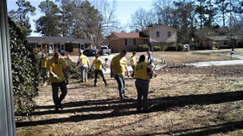 Mormon Helping Hands volunteers clean up wreckage at a house in Augusta during the Columbia County D