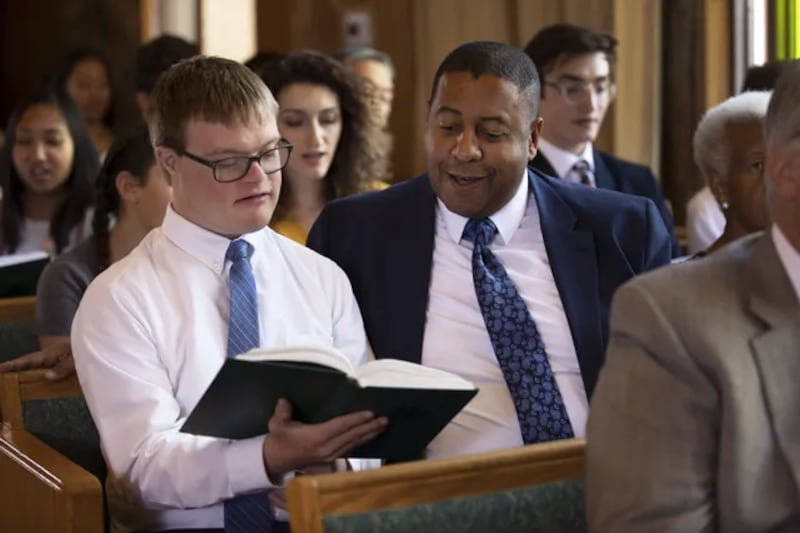 Two men sing during a Church meeting.