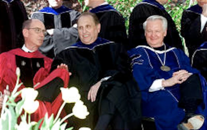 Elder Eyring (left), Pres. Thomas S. Monson and BYU President Merrill J. Bateman chat as BYU graduat