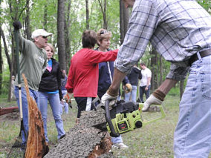 Frankfort Branch member Doug Fredin works to remove a tree that had fallen in The Union Burial Socie