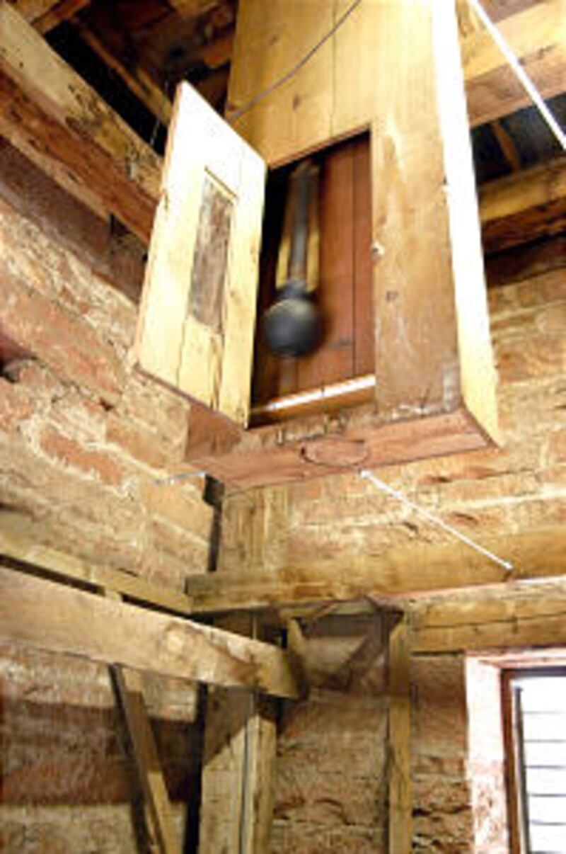 Clock was restored to its working design with a 14-foot pendulum in original wood casing.