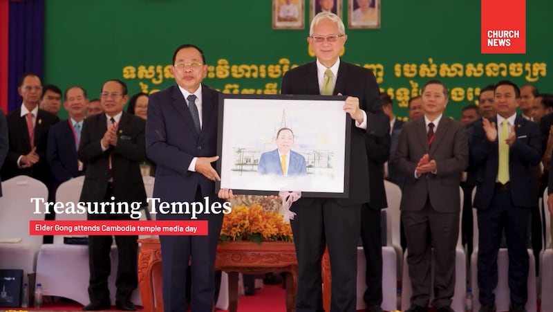 Minister Chay Borin is presented with a portrait depicting himself in front of the Phnom Penh Cambodia Temple by Elder Gerrit W. Gong.