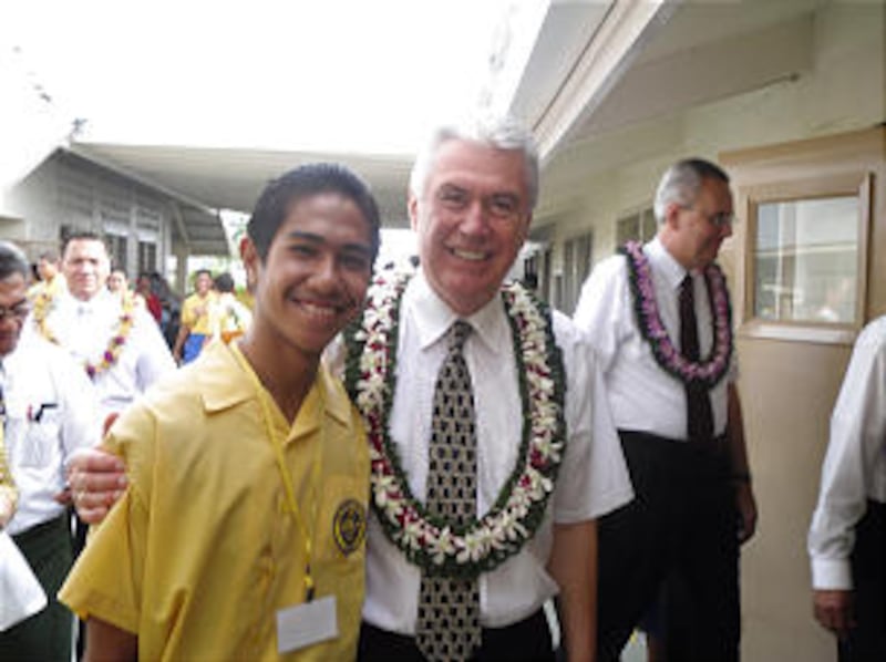 President Dieter F. Uchtdorf poses with a college student from the Church-owned college in Pesega, S