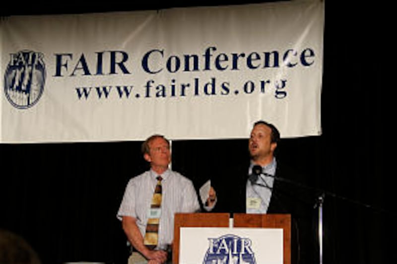 Fair board chairman John Lynch addresses audience as president, Scott Gordon looks on.