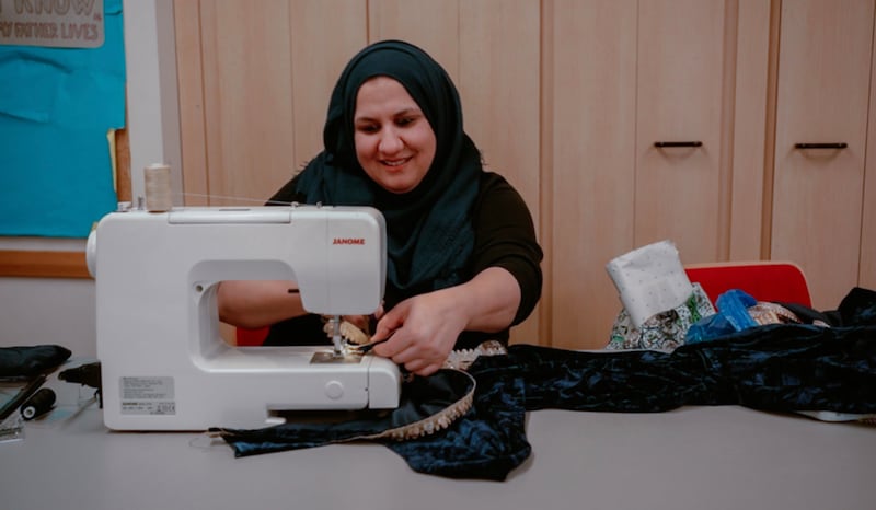 A woman participates in a sewing class held taught by Yasmin Hussein at the Wembley Friendship and Outreach Center.