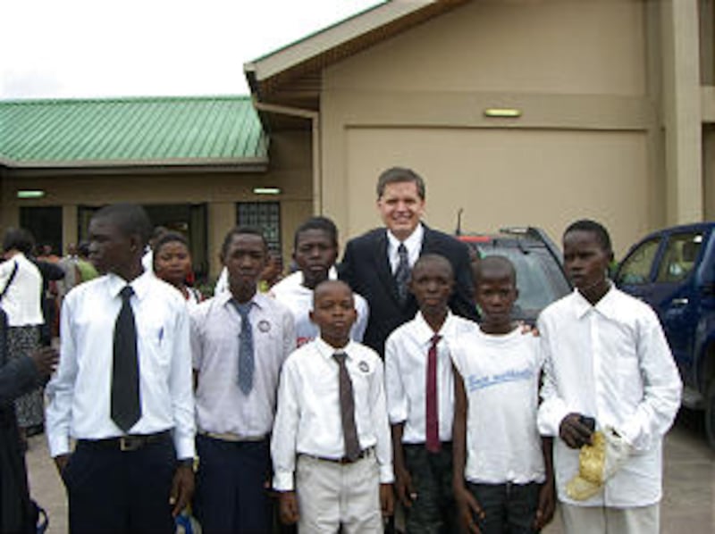 Young Men General President David L. Beck gets acquainted with young men in Kinshasa, DR Congo. In h