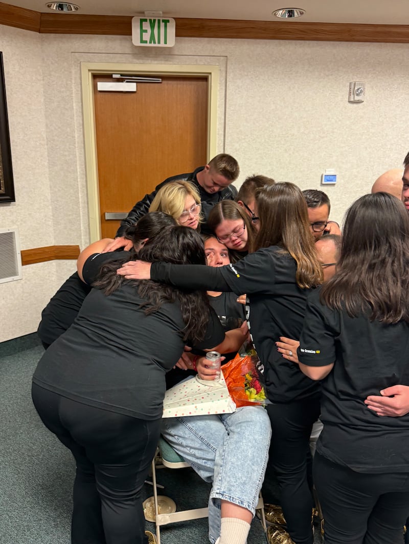 Member of the Hip Hop Homies with Xtra Chromies group embrace for a hug on Oct. 15, 2025, in Mesa, Arizona.