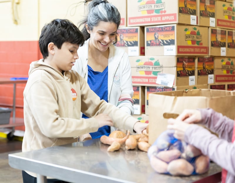 Volunteers help organize food donated by The Church of Jesus Christ of Latter-day Saints to Harvesters Food Bank in Kansas City, Missouri, on Thursday, April 23, 2026.