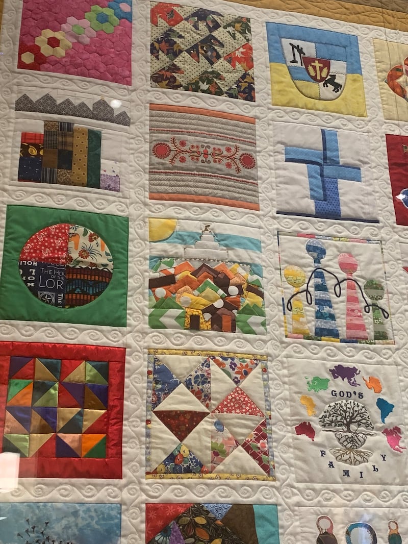 A closeup view shows individually sewn blocks in "The Family Quilt" on display at the Temple Square Visitors' Center in Salt Lake City in June 2026.