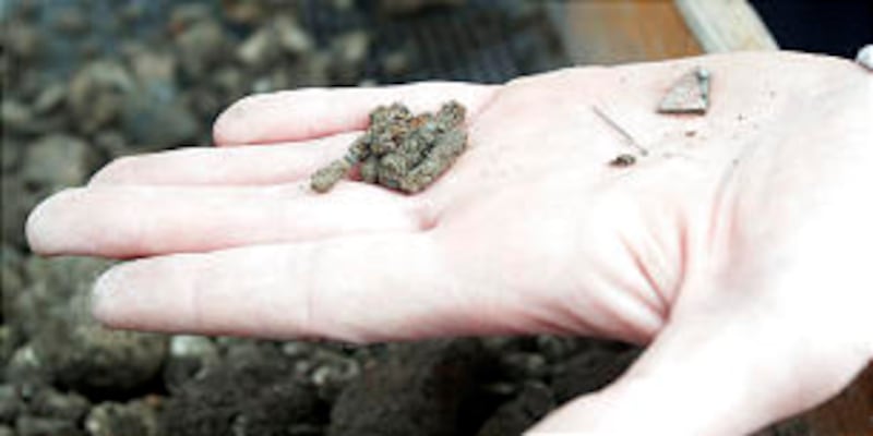 Nails, pins and glass are shown. Workers uncover the original Provo Tabernacle foundation Thursday,