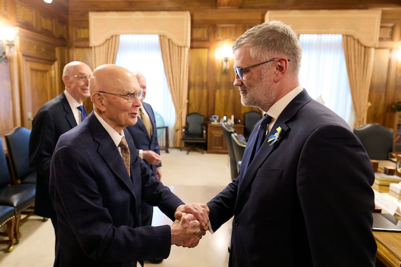 President Dallin H. Oaks, left, shakes hands with His Excellency Kristjan Prikk, ambassador of Estonia to the United States.