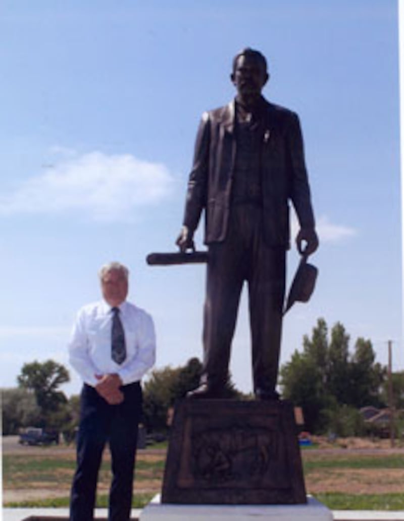 Steve Wirth stands near eight-foot-tall statue he designed of Byron, Wyo., founder Byron Sessions.