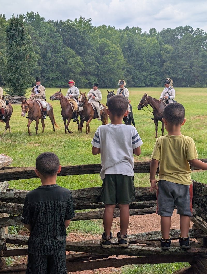 Vanessa Duerson's three sons watch a performance at Historic Brattonsville in McConnells, South Carolina, on July 11, 2026.