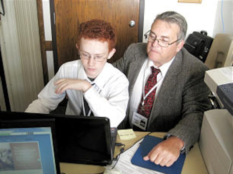 Michael Lilley sits with Steve Wright during one of the family history workshops at the Youngstown O