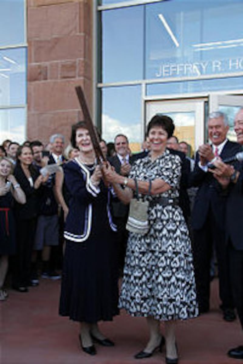 Sister Patricia Holland and Sister Margaret Nadauld cut ribbon of new building. President Dieter F.