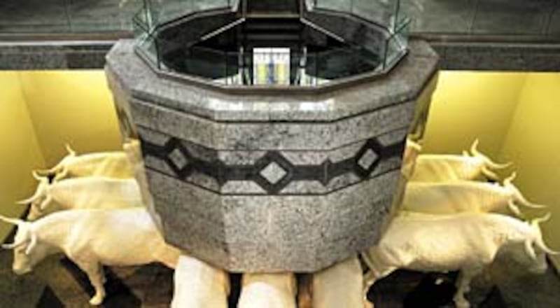 Baptismal font reflects African influence and craftsmanship.