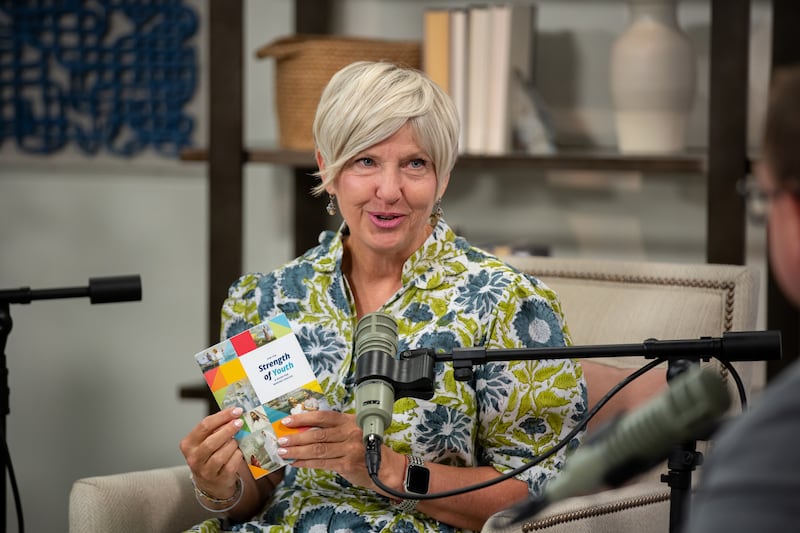 Young Women General President Emily Belle Freeman holds up a copy of the "For the Strength of Youth" guide and speaks during a recording of the Church News podcast released Monday, Aug. 31, 2026.