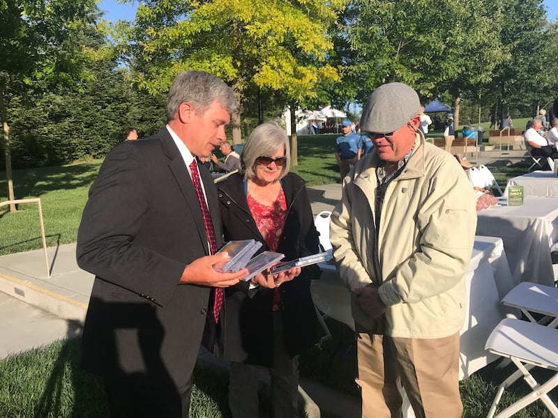 Mormon Tabernacle Choir member Paul Shafer, left, presents a handful of Mormon Tabernacle Choir CDs to Janet and Jack Reisner prior to the June 27 concert at Rohnert Park, California. The Reisners are members from nearby Santa Rosa and lost their home to last year’s wildfire. Jack Reisner’s extensive collection of choir music was also lost in the blaze.