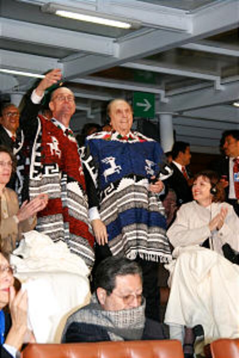 President Henry B. Eyring, left, and President Thomas S. Monson salute the Aztec Stadium crowd.