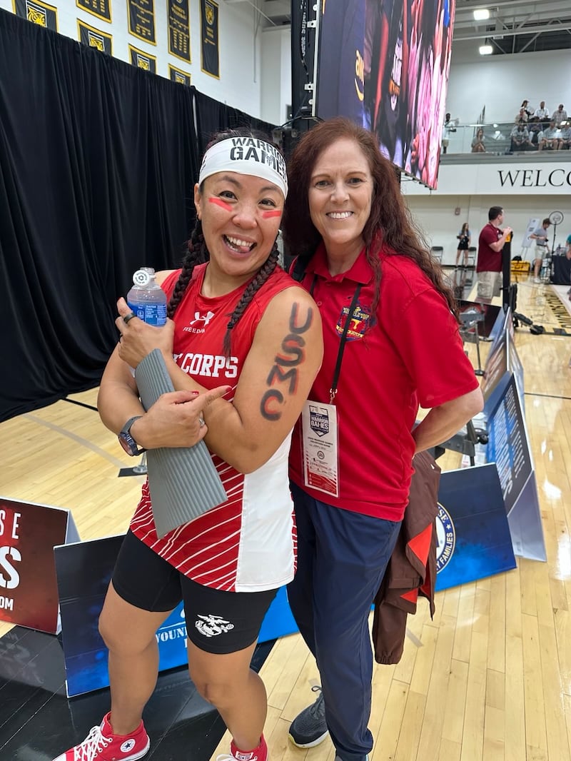 Retired U.S. Marine Maj. Yen Soto, left, takes a photo with retired Lt. Col. Mary Kate Flatley Morreli during the rowing competition at the 2025 Warrior Games in Colorado Springs, Colorado.