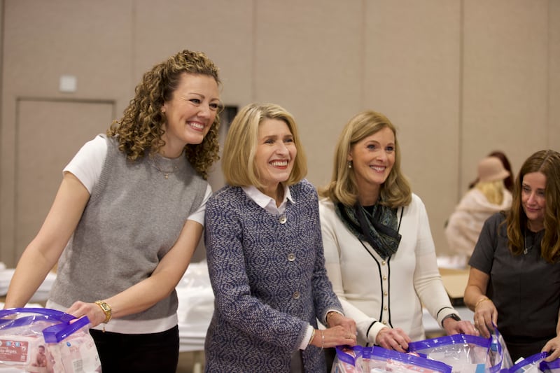 President Camille N. Johnson, Sister Andrea McConkie and Sister Sandra Singer make hygiene kits for babies for a JustServe project at the National League of Cities summit in Salt Lake City, Utah, on Thursday, Nov. 20, 2025.