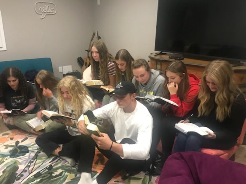 Teenagers participate in a student-led home scripture session in Draper, Utah.