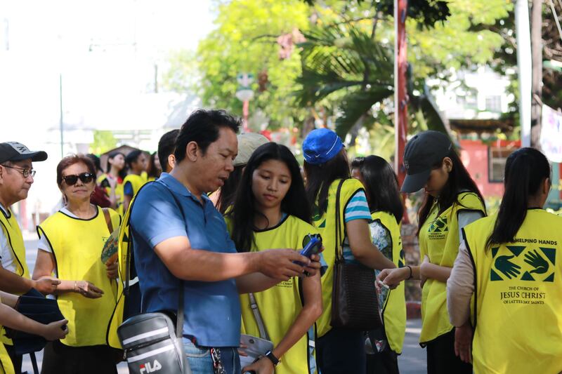 Youth and members of the Makati Philippines Stake learn how to use an online app to preserve valuabl