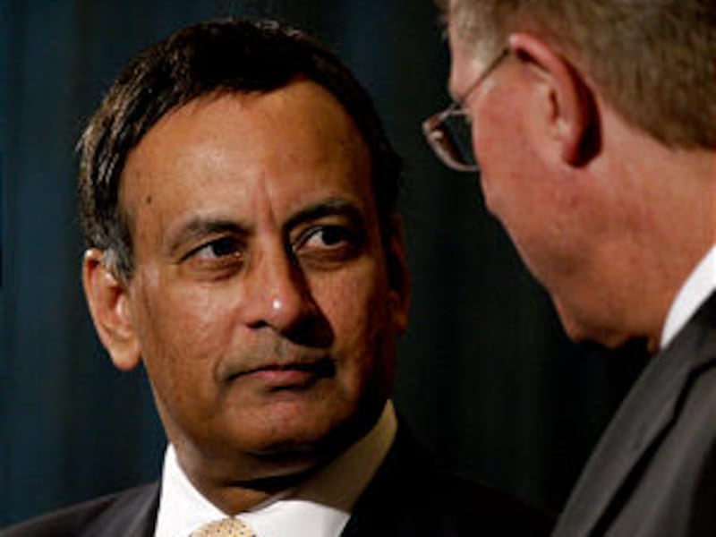 Pakistani ambassador Husain Haqqani, left, talks with, Lynn Samsel, Director of Humanitarian Service