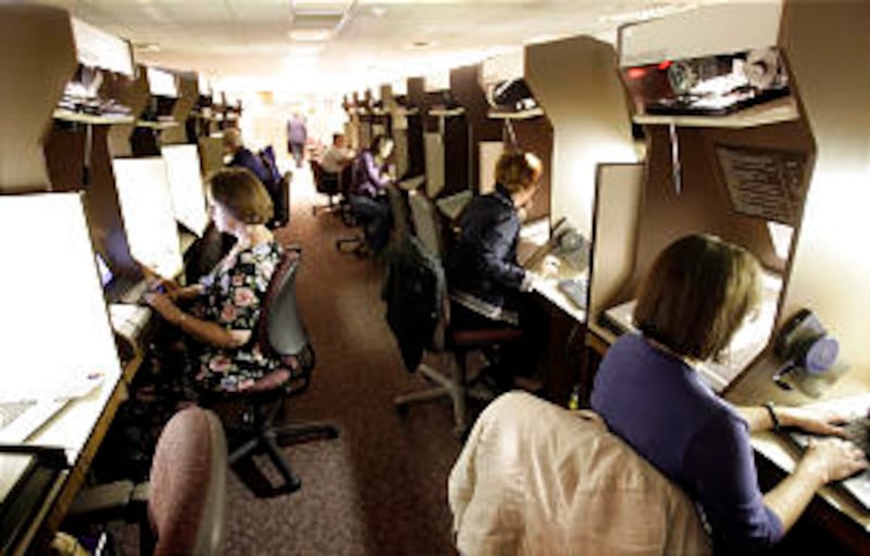 On a recent day, patrons use the microfilm readers at the Family History Library. Increasingly, comp