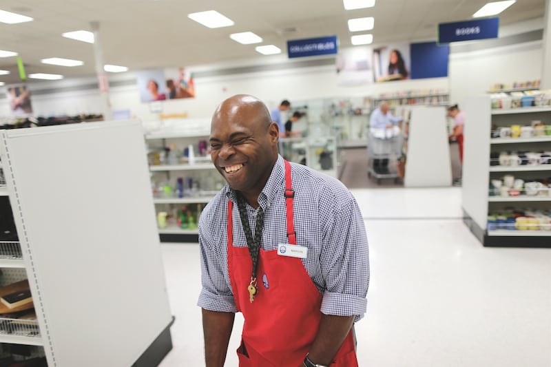 A Deseret Industries associate laughs while working.