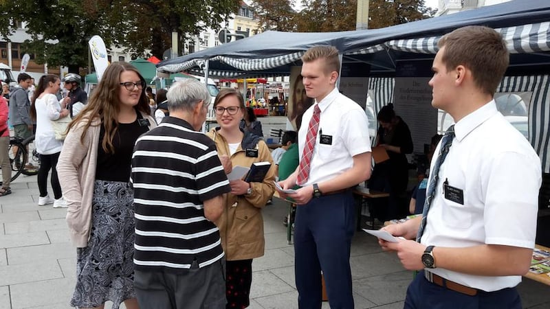 Missionaries participating in a family festival in Munich, Germany, in November 2018 present visitors with copies of “The Family: A Proclamation to the World."