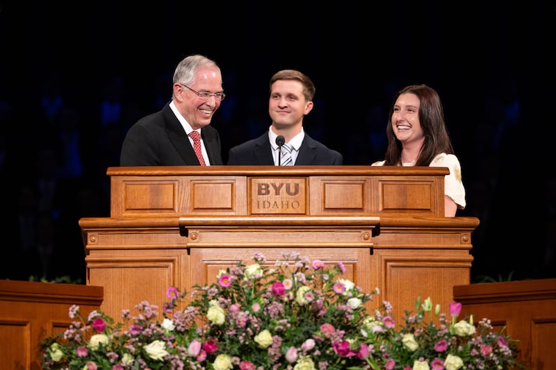 Elder Neil L. Andersen of the Quorum of the Twelve Apostles asks two students to answer a question during a devotional address in the BYU–I Center in Rexburg, Idaho, on Sunday, Feb. 22, 2026.