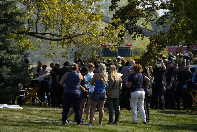 Emergency responders work the scene outside a meetinghouse of The Church of Jesus Christ of Latter-day Saints following a shooting and fire in Grand Blanc, Michigan, Sunday, Sept. 28, 2025.