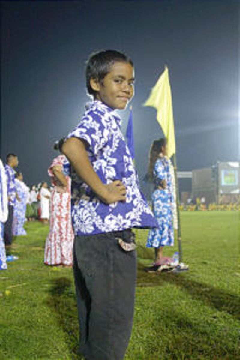 Young Hawaiian dance performer awaits his cue. Children made up much of the cultural celebration sta