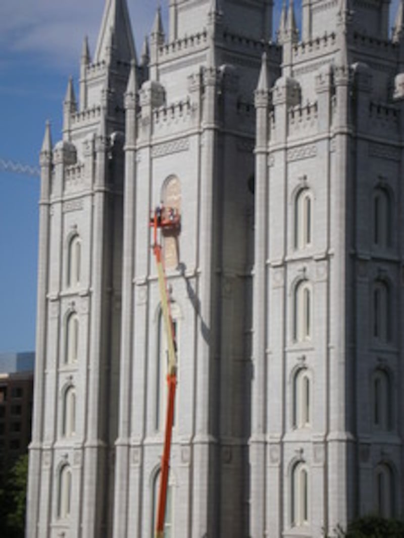 Crew works on the gold plating of the Holiness to the Lord wording on the Salt Lake Temple.