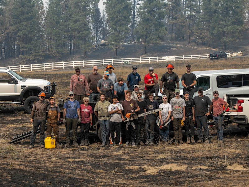 Young men and leaders from the Spokane Washington Mount Spokane Stake pause for a photo after helping to clear debris from a neighborhood damaged by wildfires in Spokane, Washington, on Monday, Aug. 3, 2026.