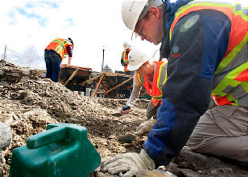 BYU Students, Katie Richards,center back, and Scott Ure, front right, dig carefully in the dirt as t