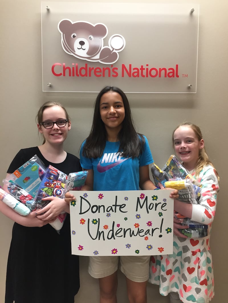 From left: Sofia Atkinson, Isabel Marchena and Mirabel Atkinson pose in the Children’s National Medical Center. The girls collected more than 7,000 pairs of underwear which they then donated to the medical center.