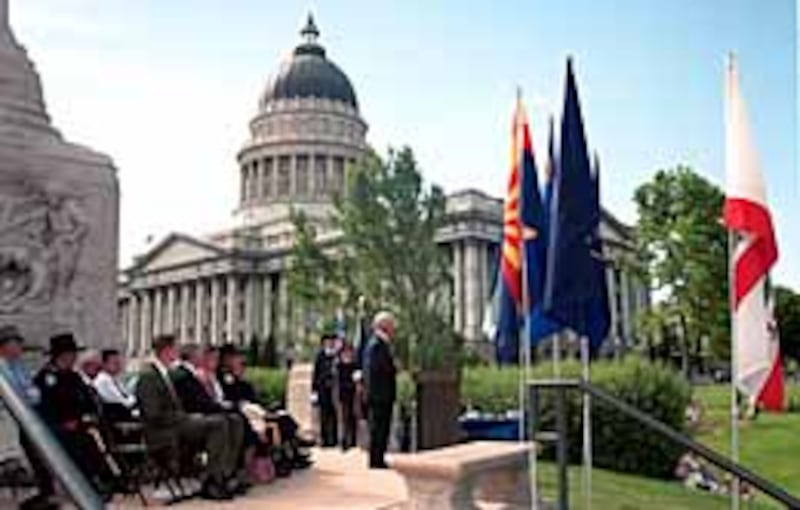 At base of Mormon Battalion Monument on Utah State Capitol grounds, Elder Marlin K. Jensen delivers